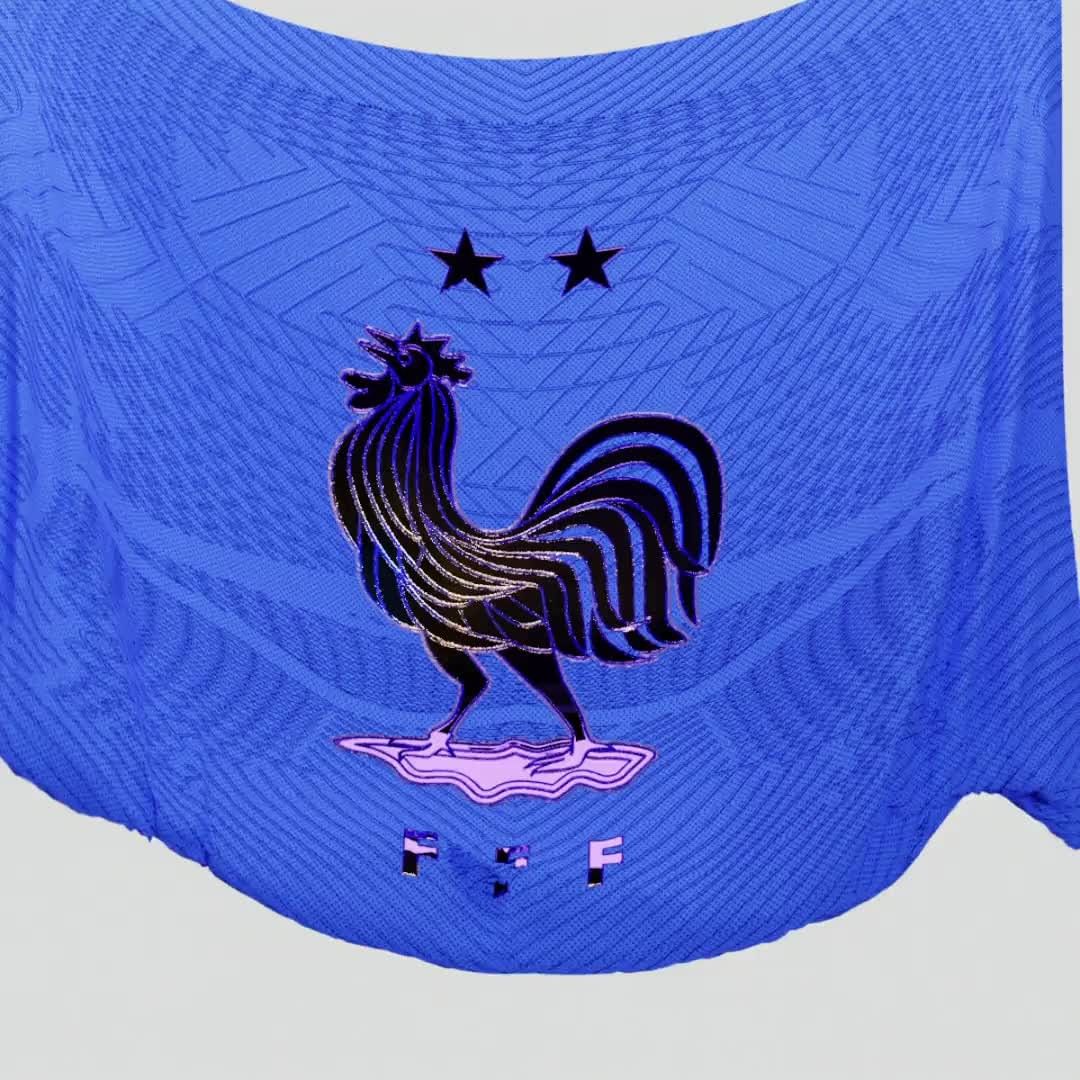 Close-up of a blue France soccer jersey featuring the team's crest, two stars, and the letters 'FFF' on a light gray background.
