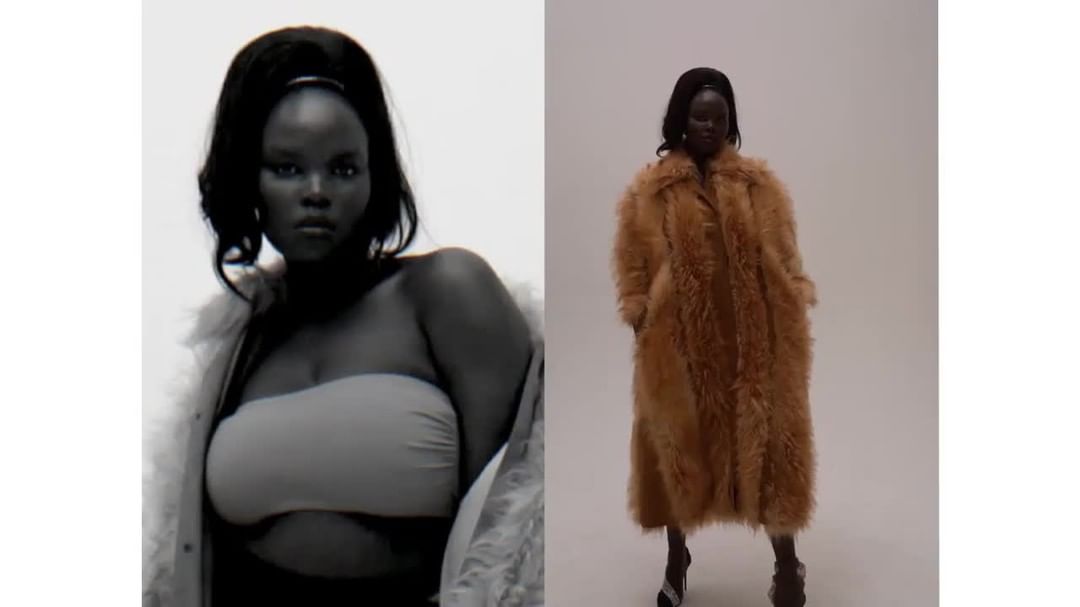 Editorial shot of a Black woman in a beige top and fur coat against a white backdrop. Fashionable hairstyle and confident expression.