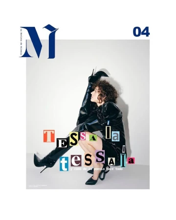 Editorial fashion cover with a woman in a shiny black dress and knee-high boots, crouching against a white backdrop with magazine text.
