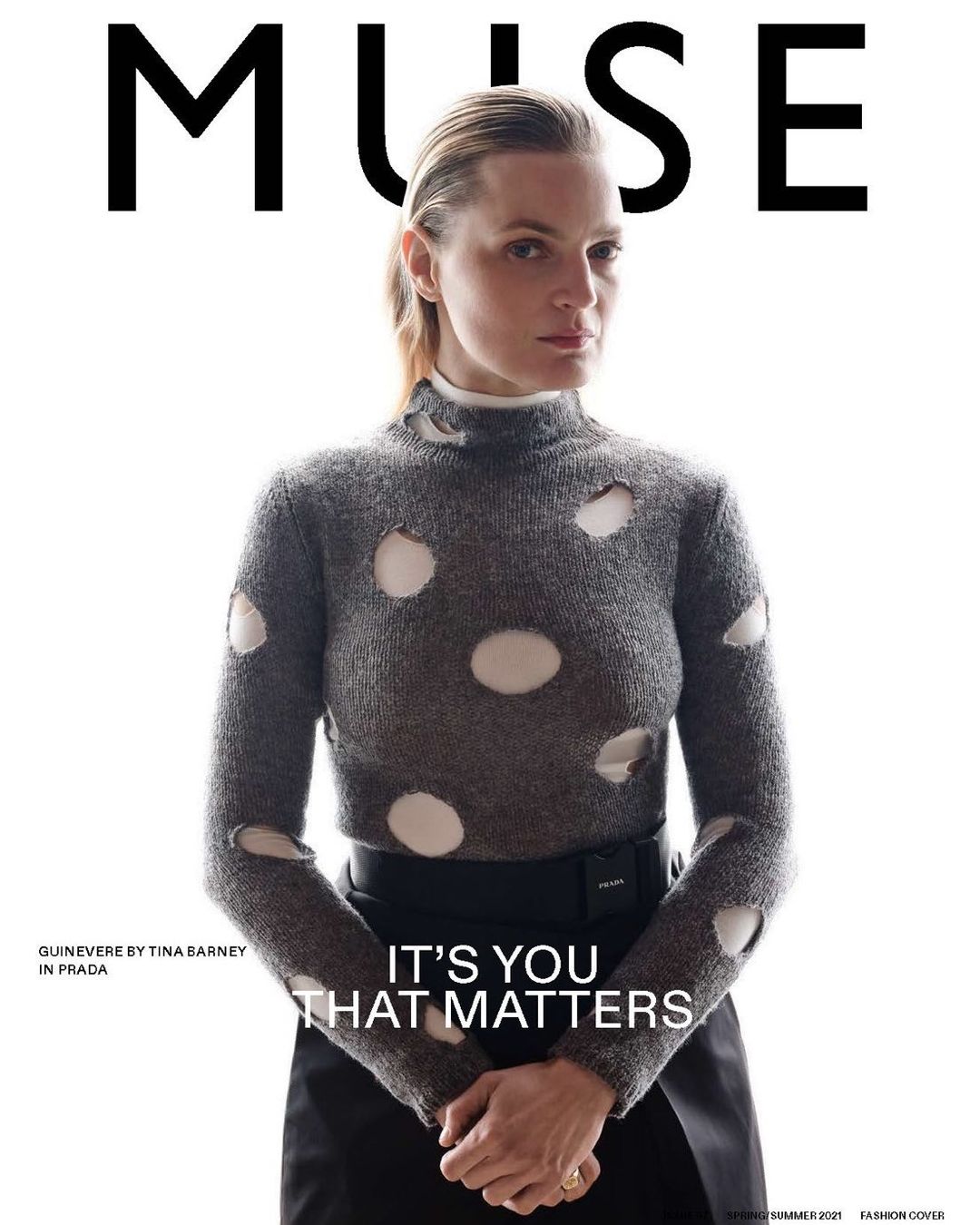 Magazine cover featuring an adult female with light skin wearing a grey sweater with white holes, a black skirt, and the text "MUSE".