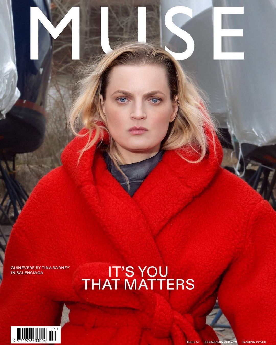Magazine cover featuring a blonde woman in a red coat, posing in front of a blurry backdrop with the white title text 'MUSE' above her.