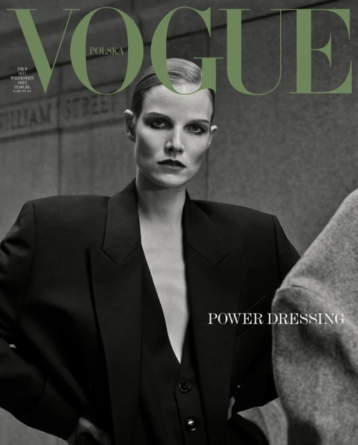 Vogue Polska cover featuring a model in a black blazer and vest against a muted wall backdrop. "Power Dressing" is featured text.