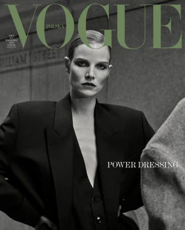Vogue Polska cover featuring a model in a black blazer and vest against a muted wall backdrop. "Power Dressing" is featured text.