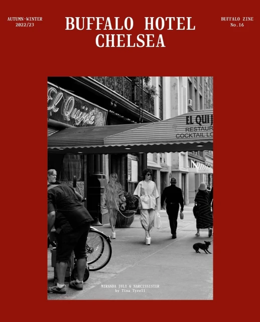 Black and white street scene featuring people walking near a restaurant with awnings, captured in a vintage, editorial style.