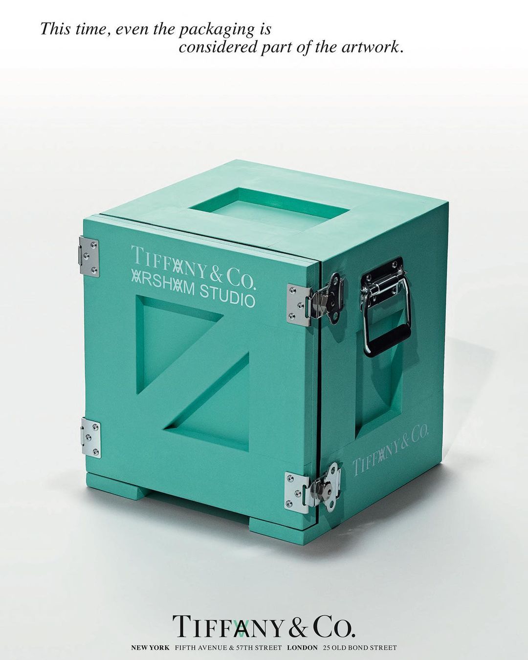 Tiffany & Co. x Arsham Studio turquoise box with silver hardware, sitting on a white surface in a minimalist advertisement.
