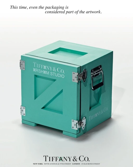 Tiffany & Co. x Arsham Studio turquoise box with silver hardware, sitting on a white surface in a minimalist advertisement.