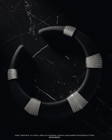 Boucheron Sable Noir white gold collar necklace with diamonds displayed on black marble background in a studio shot.