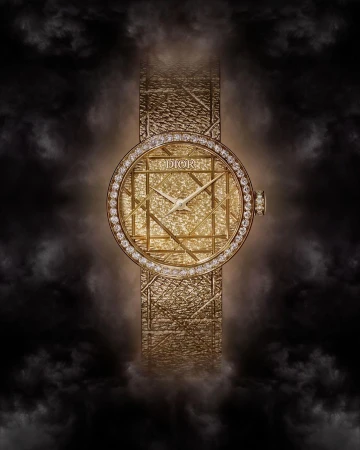 Elegant gold Dior watch with diamond bezel and textured band against a soft black smoky background in a beauty and fashion editorial shot.