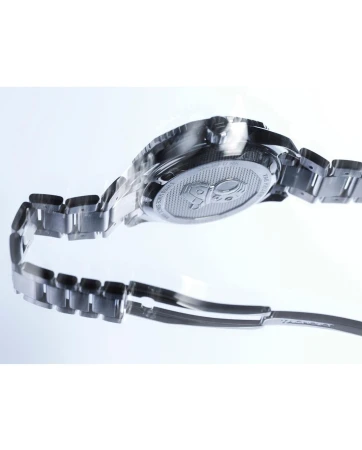 Back view of a silver TAG Heuer wristwatch with a metal bracelet on a reflective white surface in a studio setting. 