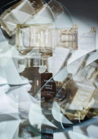 Multiple overlapping exposures of Tom Ford perfume bottles creating a kaleidoscopic abstract composition