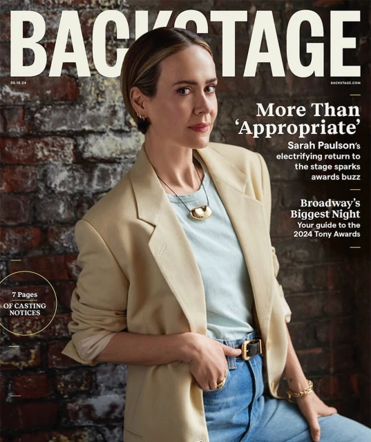 Backstage magazine cover featuring Sarah Paulson, wearing a blazer, T-shirt, and jeans, set against a textured brick wall backdrop.