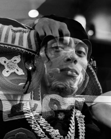 Monochrome multiple exposure portrait of a man wearing a beanie and layered chains by photographer Tom Ivin in London