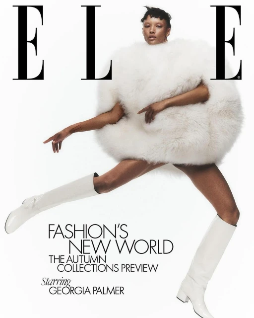 Fashion magazine cover featuring a model in an oversized white faux fur coat and matching white boots, posing against a white backdrop.
