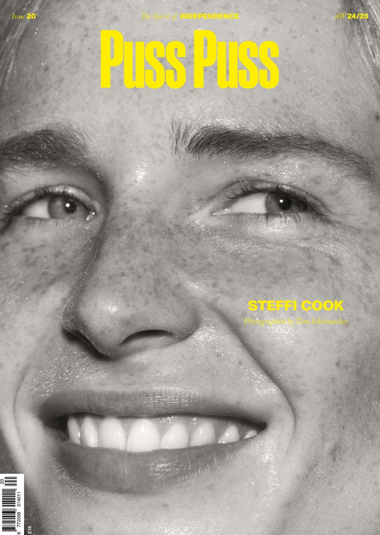 Close-up magazine cover photo of Steffi Cook in black and white with yellow title text 'Puss Puss'. Skin is visible with freckles.