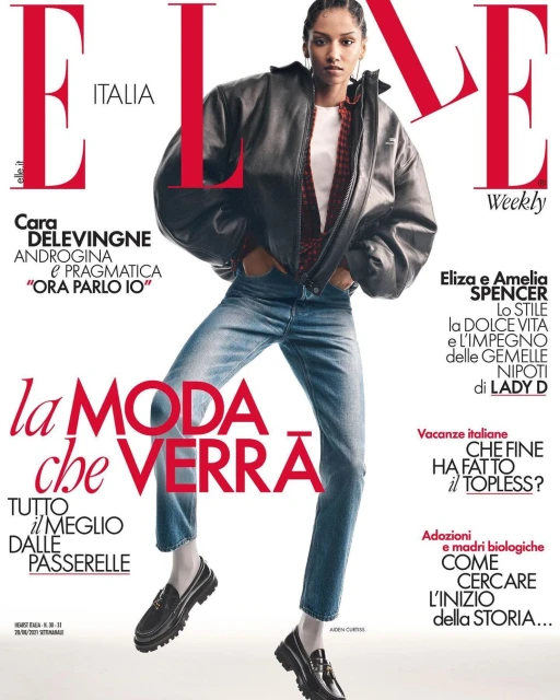 Elle Italia magazine cover featuring a female model wearing a black jacket, jeans, and loafers, posing against a white backdrop with magazine text.