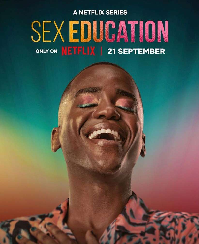 Promotional poster for the Netflix series 'Sex Education,' featuring a smiling African American adult with colorful eye makeup.