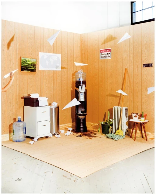 Office break room with flying paper airplanes, spilled coffee, and a water cooler; a humorous and chaotic office still life scene.