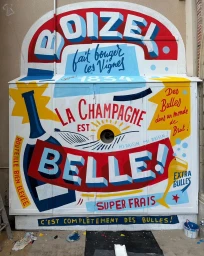 Colorful hand-painted mural with bold typography and vintage French champagne graphics on a metal utility box