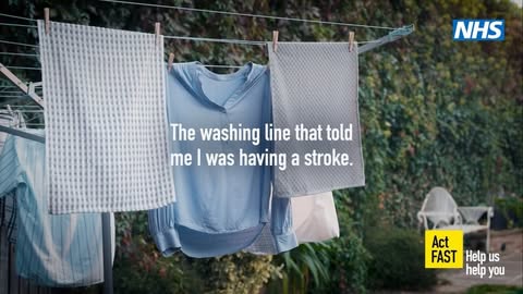 Washing line with hanging clothes and a health message about recognizing signs of a stroke on an outdoor background, sunny day.