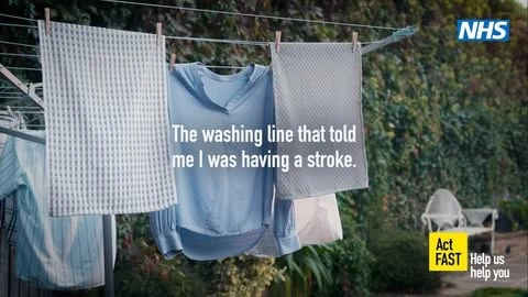 Washing line with hanging clothes and a health message about recognizing signs of a stroke on an outdoor background, sunny day.