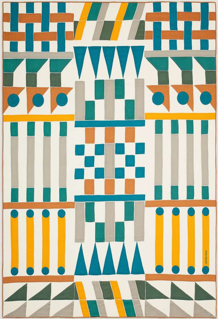 Abstract geometric textile art with repeating triangles, circles, squares, and bars in teal, orange, yellow, and grey on an off-white ground.
