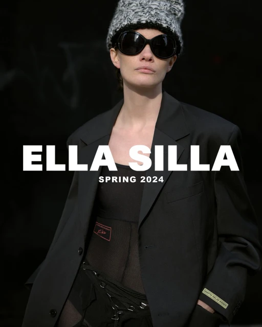 Fashion shot of a woman wearing a black blazer, knit hat, and sunglasses against a dark background with the text 'Ella Silla Spring 2024'.