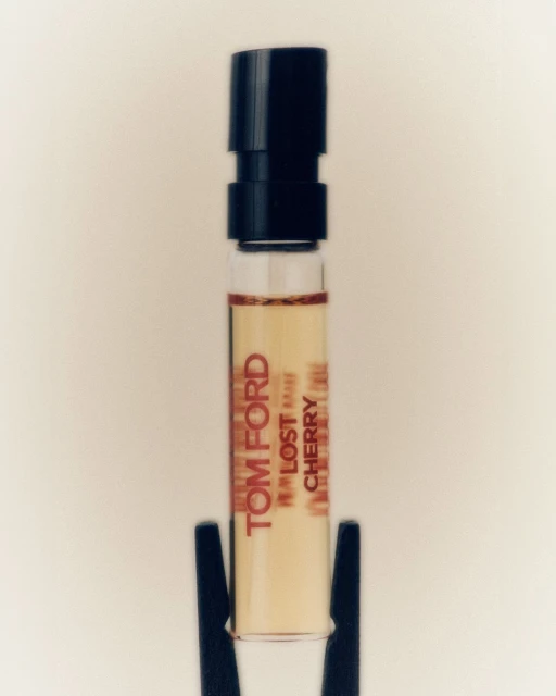 Tom Ford Lost Cherry perfume sample vial with black cap on white background for beauty and fragrance product shot.