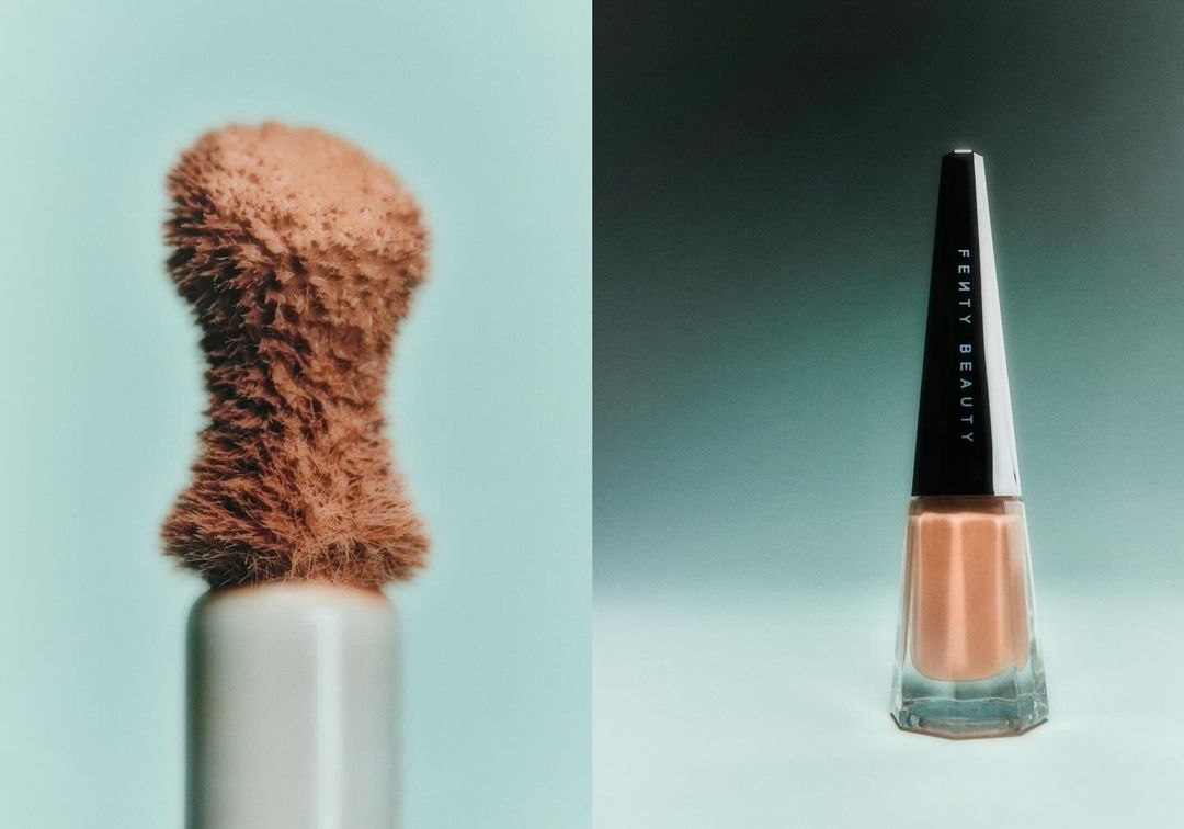 Close-up studio shot of Fenty Beauty makeup applicator brush and nail polish bottle against gradient teal background.