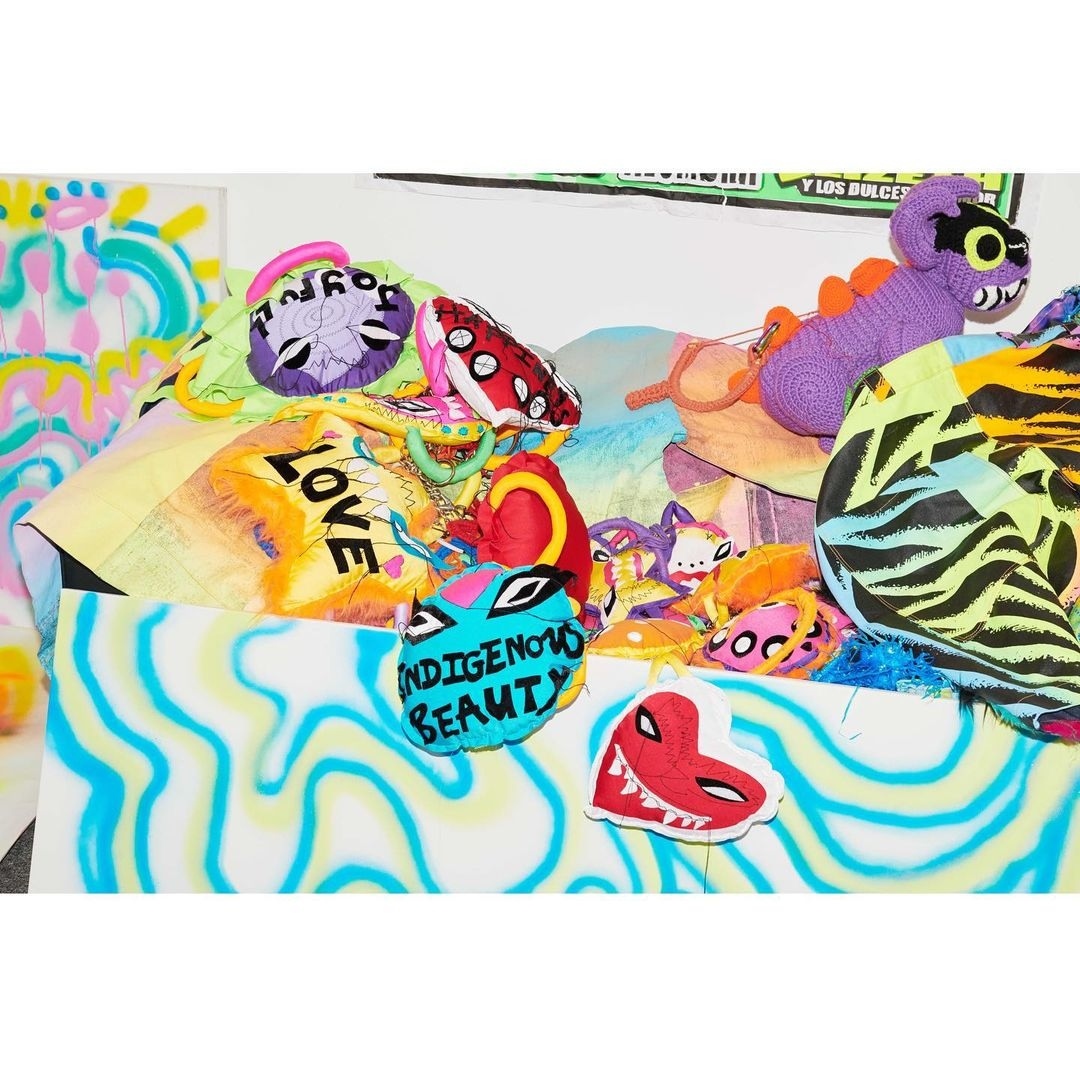 Colorful assortment of plush toys and fabric scraps with text, set against a white background with light blue and yellow wave patterns.