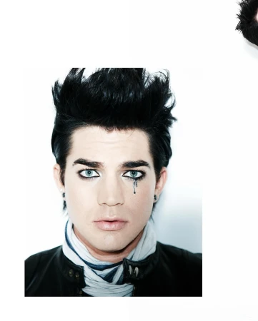 Portrait of Adam Lambert with black spiky hair, heavy eyeliner, and a painted tear beneath his left eye