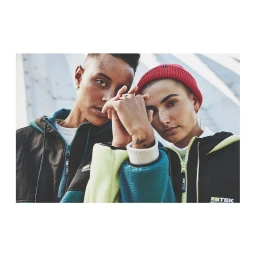 Two models wearing fleece jackets and holding hands outdoors in a low-angle portrait by Ture Lillegraven.