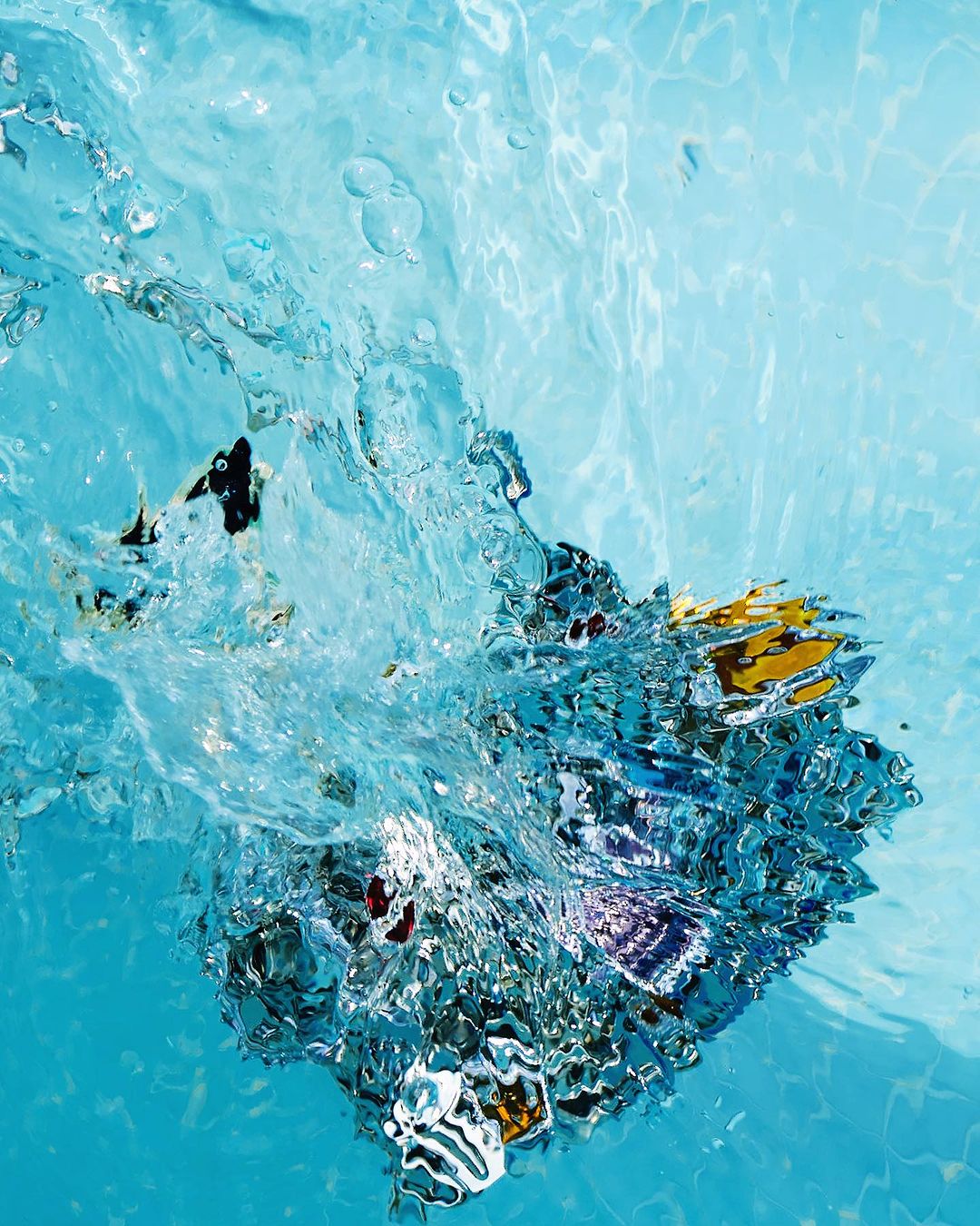 Abstract underwater shot of water and light, featuring reflections, refraction, and ripples creating an interesting visual texture.