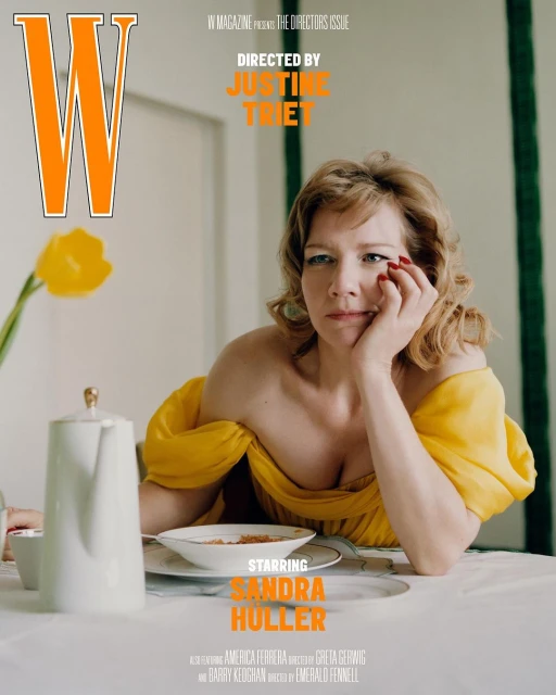 W Magazine cover featuring Sandra Hüller wearing a yellow dress, sitting at a table with a teapot and flowers in the background.