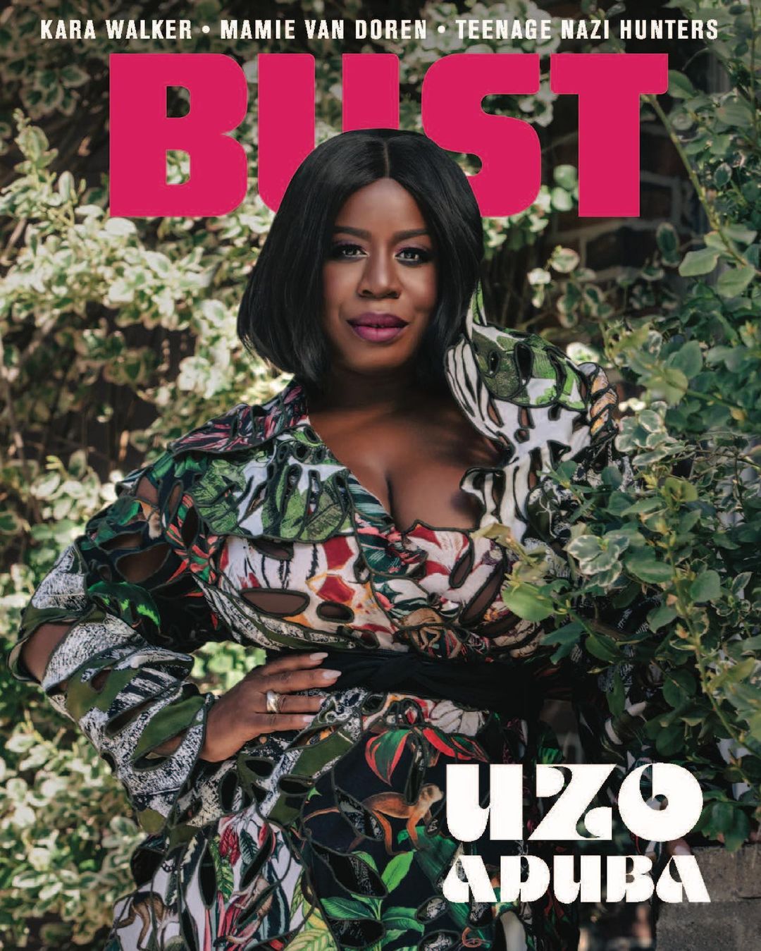 Uzo Aduba featured on the cover of Bust magazine, posing outdoors with foliage in the background, wearing a floral-print dress.