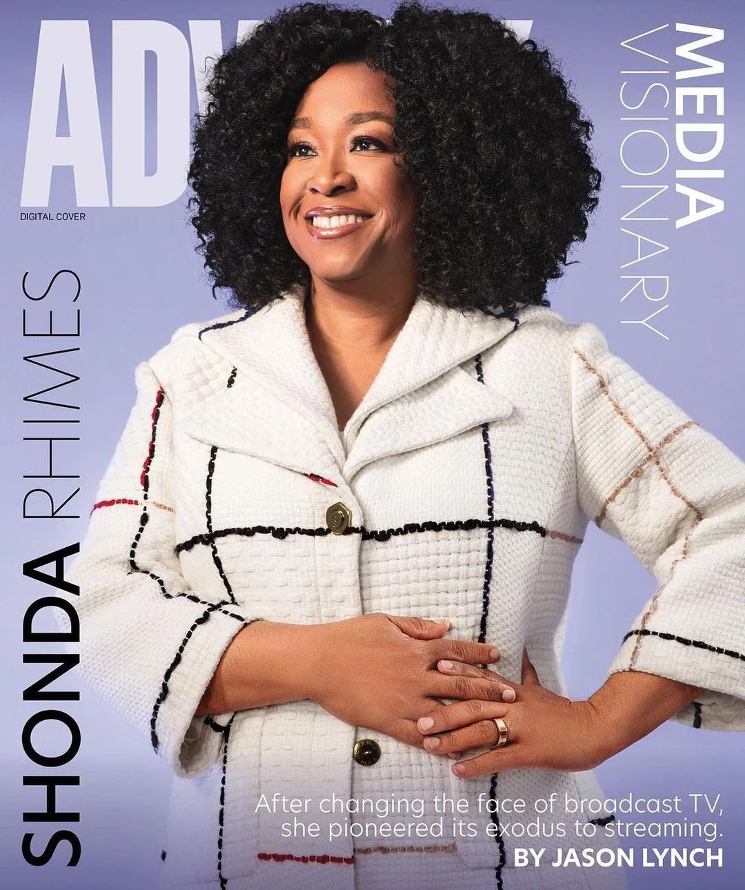 Portrait of Shonda Rhimes wearing a white plaid blazer against a pale purple background, photographed by Tyler Twins.