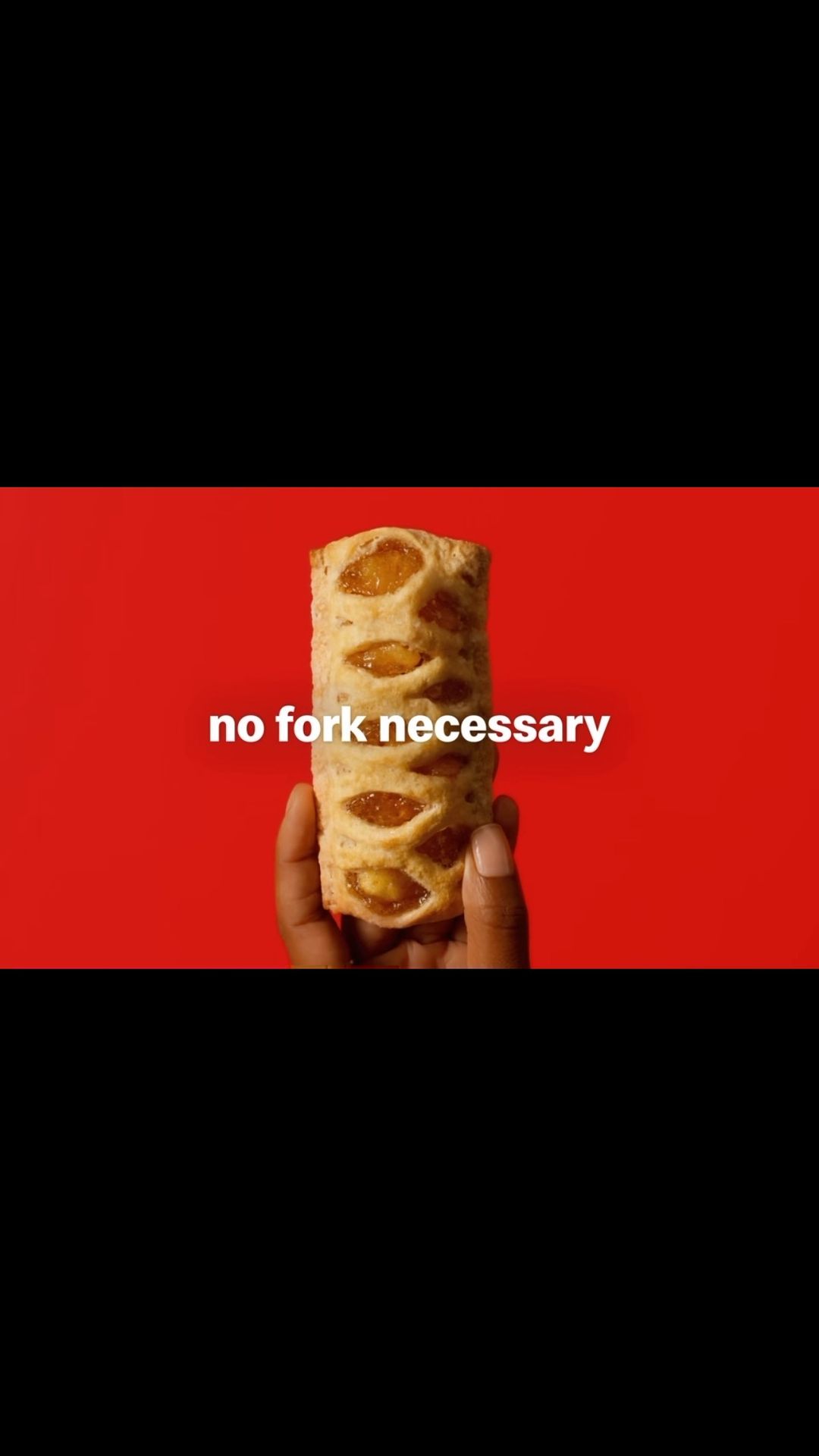 Hand holds a vertical, pastry-wrapped food item on a red background with the text, 'no fork necessary' in white letters.