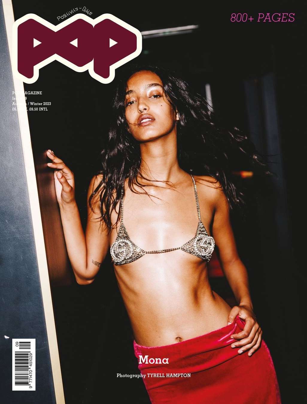 Mona Tougaard graces POP Magazine cover, wearing a sequined bikini top and red velvet skirt, captured in a dimly lit indoor setting.