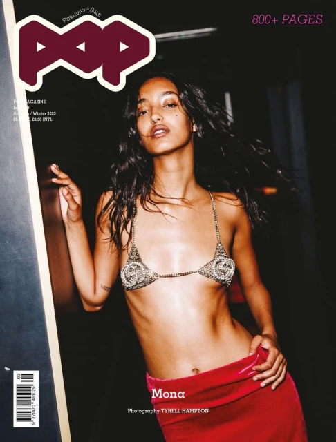 Mona Tougaard graces POP Magazine cover, wearing a sequined bikini top and red velvet skirt, captured in a dimly lit indoor setting.
