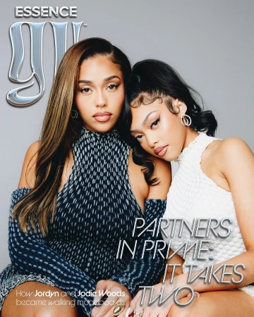 Two women posing together for an editorial portrait photographed by Tyrell Hampton against a plain grey background