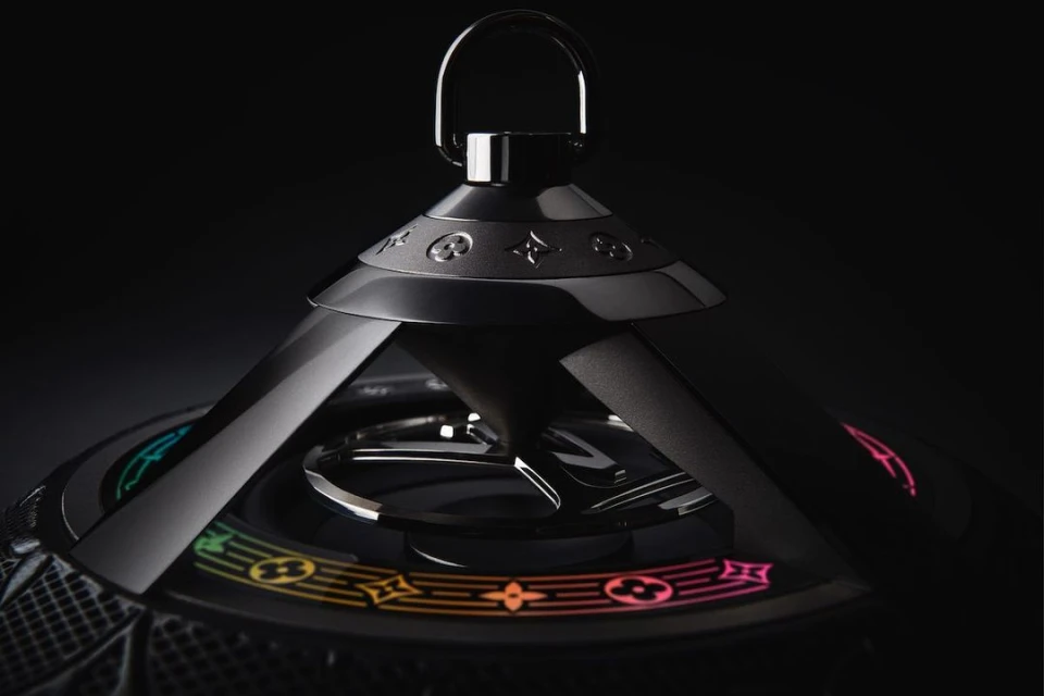 Close-up of a black Louis Vuitton speaker with colorful logo details. Product shot with a dark background, highlighting the speaker's design.