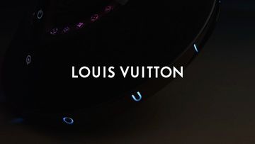 Louis Vuitton logo display in a dark setting, emphasizing brand visibility with contrasting black background.