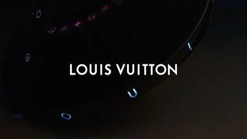 Louis Vuitton logo display in a dark setting, emphasizing brand visibility with contrasting black background.