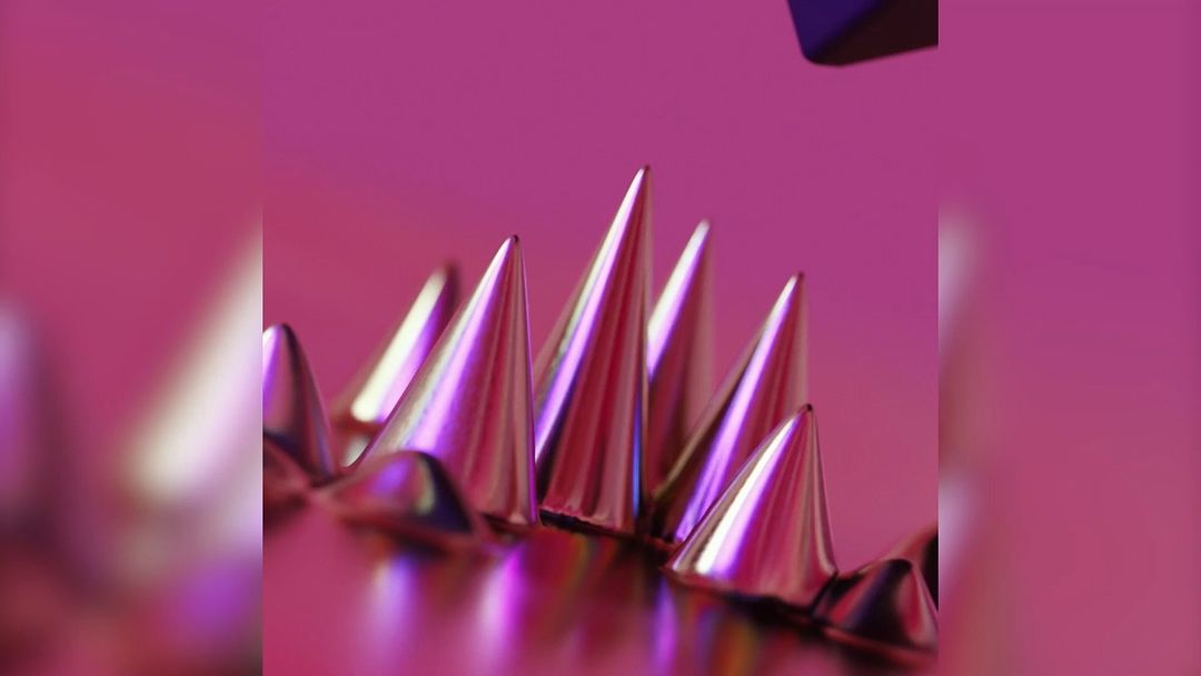 Pink conical forms create an abstract, textured background with metallic, spiked shapes on a shiny surface, enhancing visual depth.
