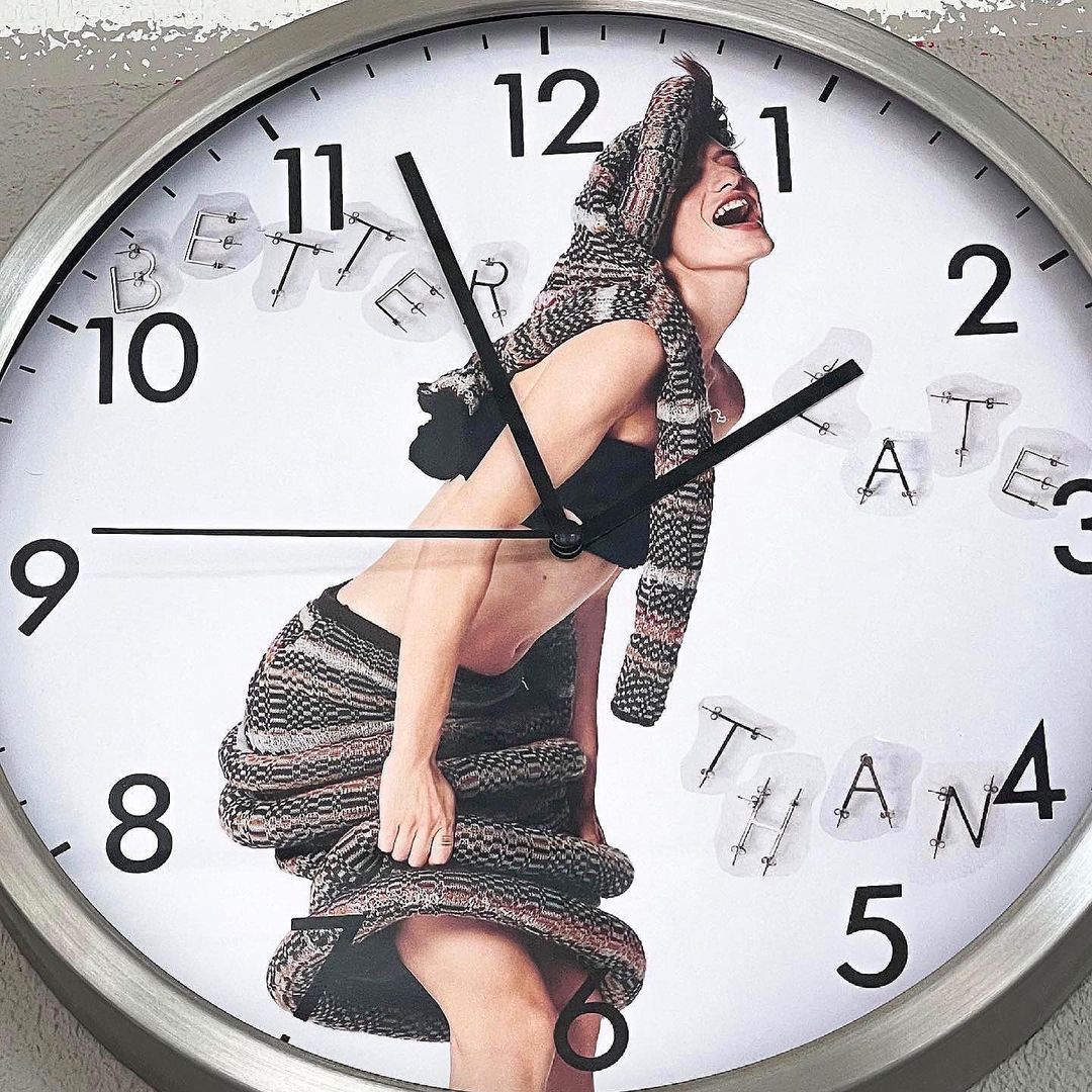 Artistic clock featuring woman in knitwear, juxtaposed with clock face and lettering. A unique, fashion-forward time-telling piece.