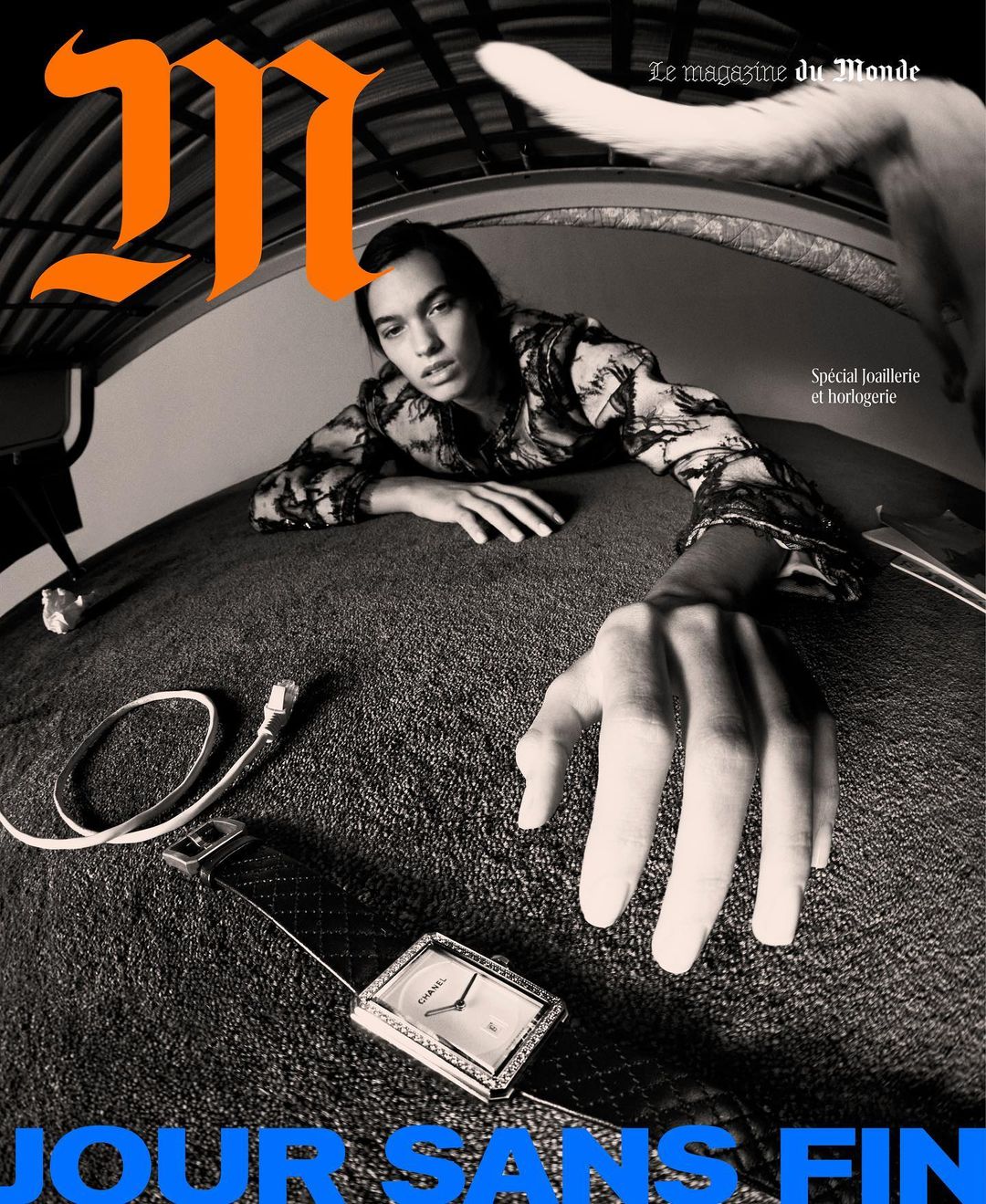 Magazine cover featuring a person with jewelry, a watch, and an open hand, creating a surreal and fashionable scene with monochrome grading.