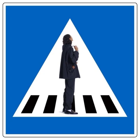 Person in dark suit on pedestrian crossing sign.  Conceptual shot of modern fashion with blue and white graphic design.
