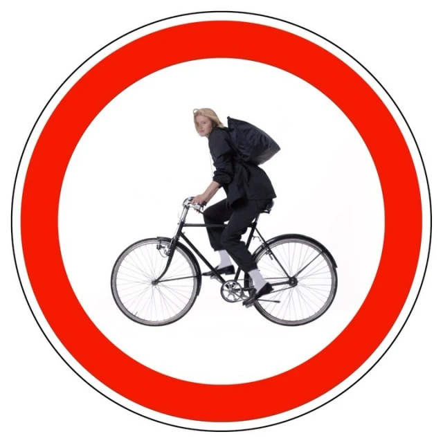 Person riding a black bicycle inside a red circle with a white background, evoking a road sign symbolizing 'no bicycles allowed'.