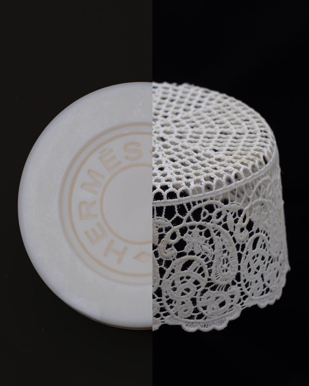 Still life split image featuring a round soap with the Hermès logo, and a white lace object against a stark black background.