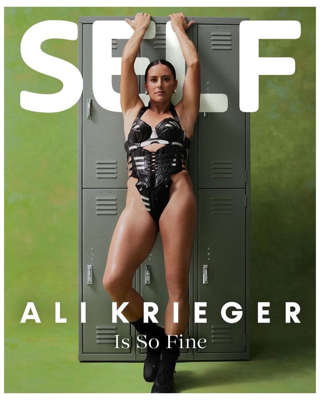 Athletic woman in a black bodysuit leans against grey lockers. Magazine cover. Ali Krieger is So Fine. Green and grey tones dominate.