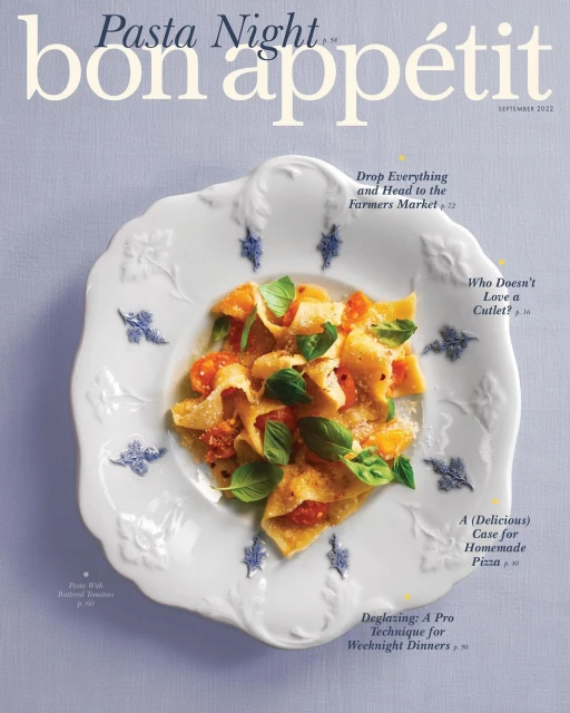 Close-up of Bon Appetit magazine cover featuring a plate of pasta with tomatoes and basil, set against a light purple background.
